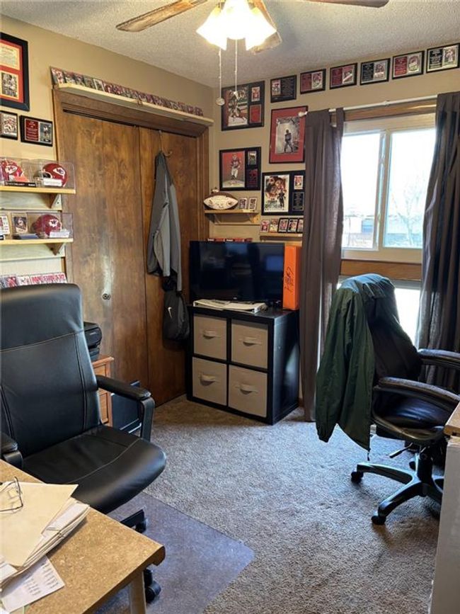 Carpeted office or Bedroom 3 featuring screened window, closet and ceiling fan | Image 14