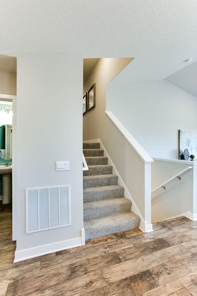 This smart layout is just seven steps up or down to the additional living areas. Photos of model home. Colors and options may vary. Ask Sales Agent for details. | Image 18