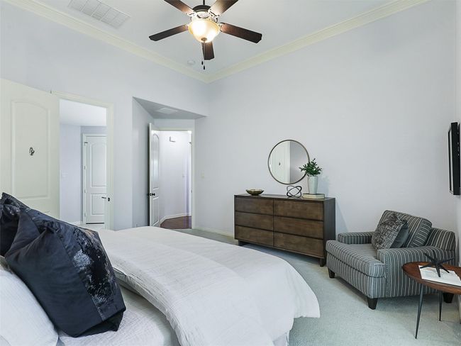 Bedroom featuring light carpet, crown molding, and a ceiling fan | Image 20