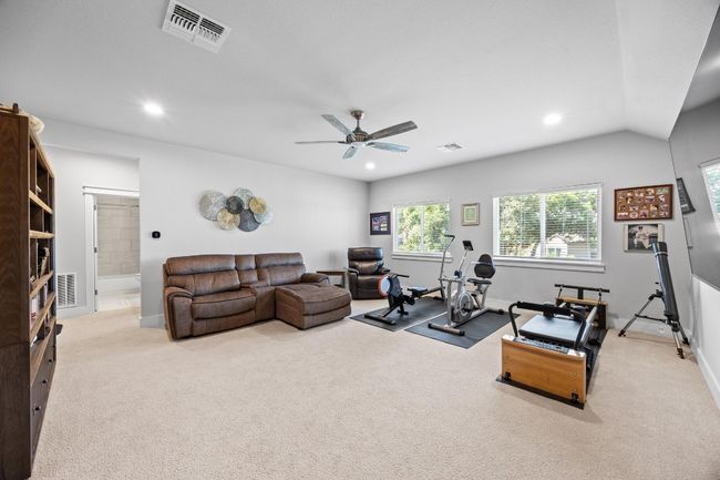 Upstairs bonus room spanning over 700 square feet provides extra living space, complete with a private suite that includes its own ensuite bathroom and a generous walk-in closet featuring a custom-designed built-in storage system. This versatile area is ideal for multi-generational living or accommodating visiting guests. | Image 33