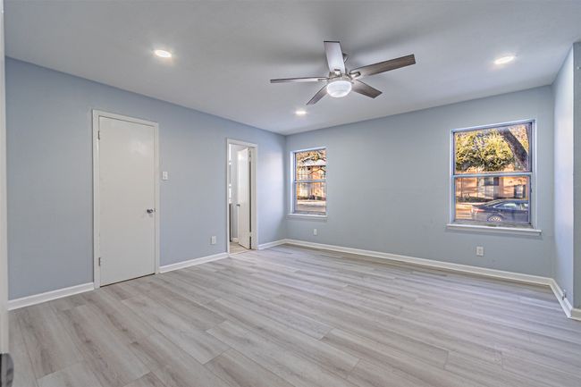 Spare room featuring ceiling fan, a healthy amount of sunlight, and light hardwood / wood-style floors | Image 28
