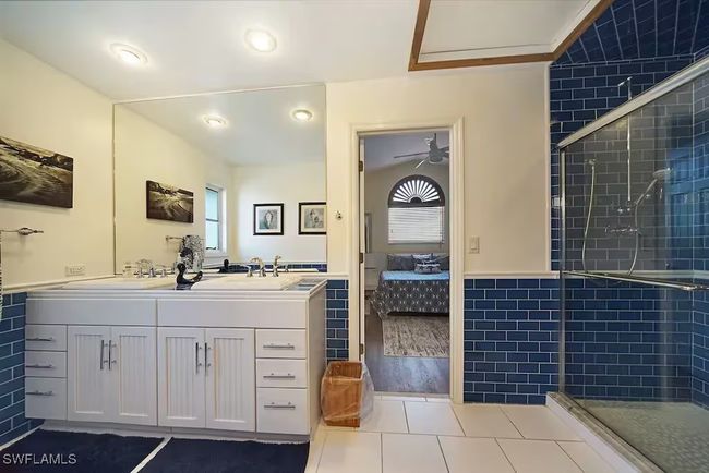 Bathroom featuring ensuite bathroom, a shower stall, double vanity, and tile patterned flooring | Image 27