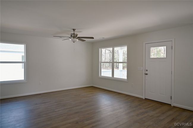 Entrance foyer with ceiling fan, plenty of natural light, and dark hardwood / wood-style floors | Image 7