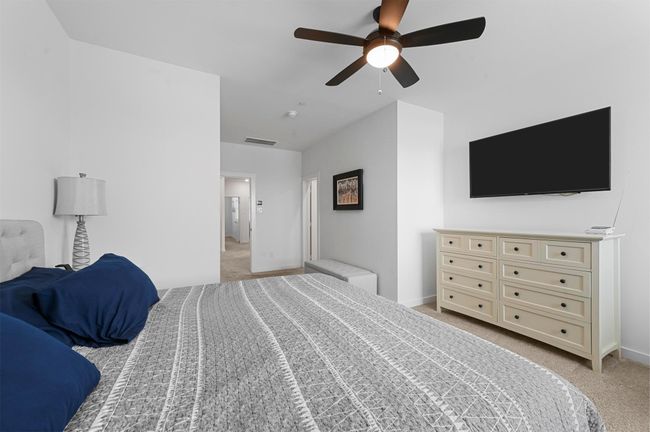 Carpeted bedroom featuring ceiling fan | Image 19