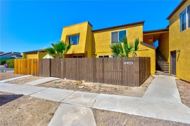 View of property featuring a fenced front yard, stairs, and stucco siding | Image 8