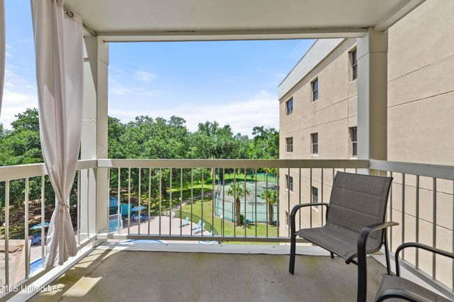 balcony overlooking pool area | Image 8