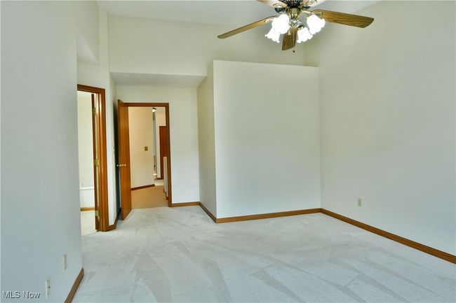 Empty room featuring ceiling fan and light carpet | Image 38