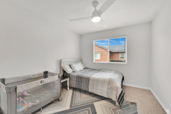 Bedroom with carpet flooring, baseboards, and ceiling fan | Image 17