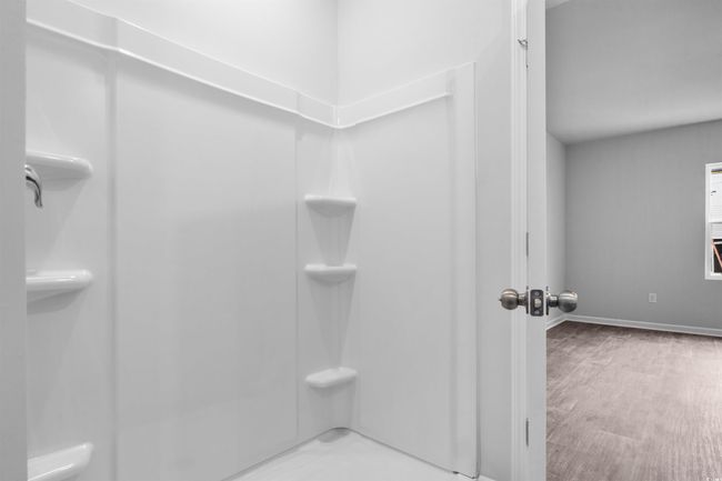 Full bathroom with wood finished floors, double vanity, a sink, baseboards, and a spacious closet | Image 7