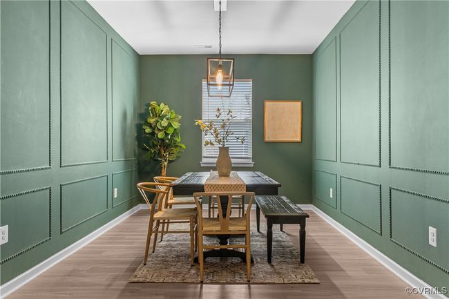 Dining room with wood finished floors, a decorative wall, and baseboards | Image 26