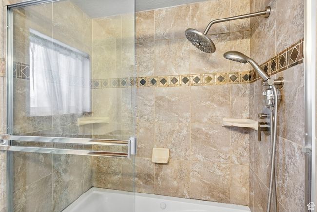 Bathroom with a tile shower | Image 40