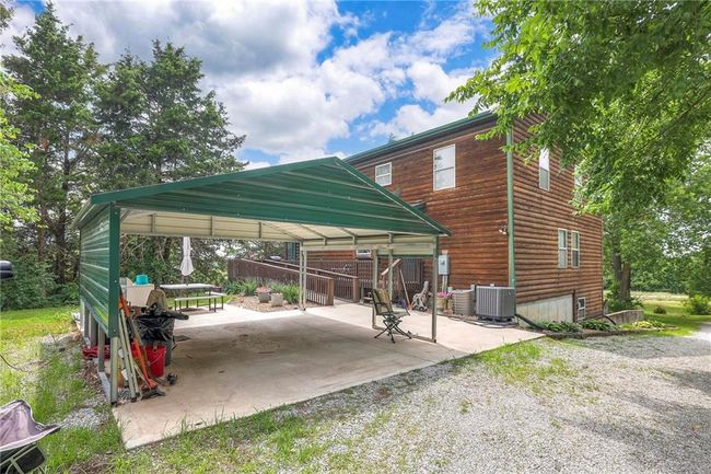 View of vehicle parking featuring a gazebo, a carport, and driveway | Image 47