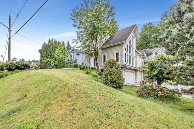 View of green lawn with an attached garage | Image 5