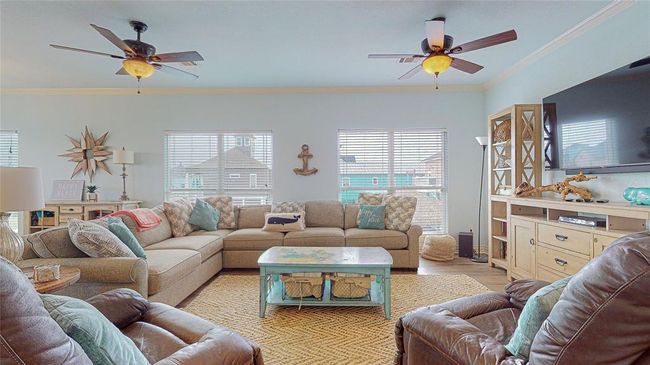 This fully furnished home is bathed in natural light, offering beautiful views of the canal right from your living room. Keep a look out for all of the turtles! | Image 11