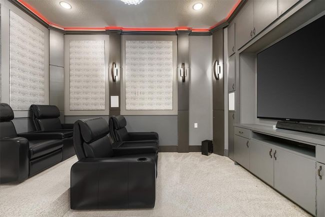 Tucked behind the custom, hidden shelves, you'll find this fully custom home theater. | Image 5