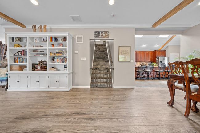 Kitchen featuring stainless steel appliances, a sink, a skylight, radiator, and a kitchen bar | Image 14