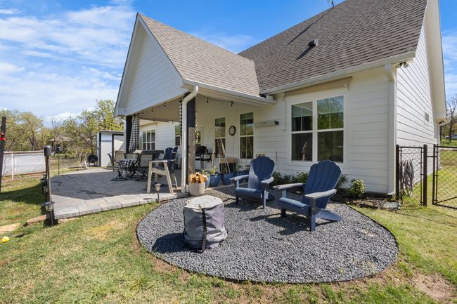 Back of house featuring a patio, fence, roof with shingles, and a lawn | Image 35