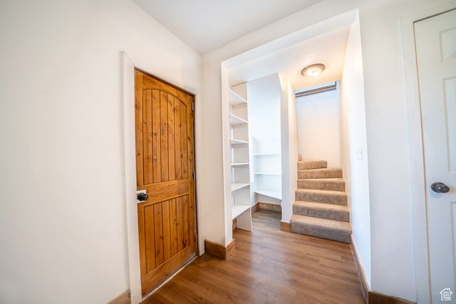 Hallway with stairway, baseboards, and wood finished floors | Image 14