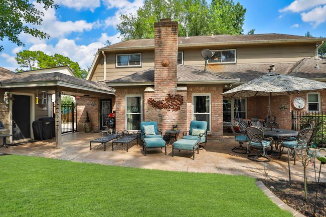 This inviting backyard features an expansive back pation with a stone patio that was installed in 2021. | Image 26