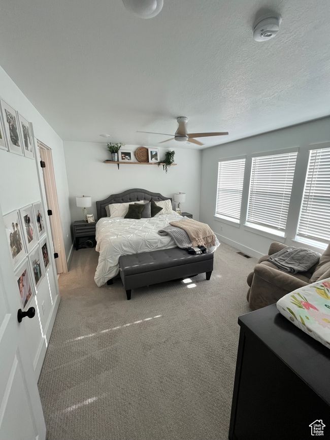 Bedroom featuring carpet floors, baseboards, and ceiling fan | Image 14