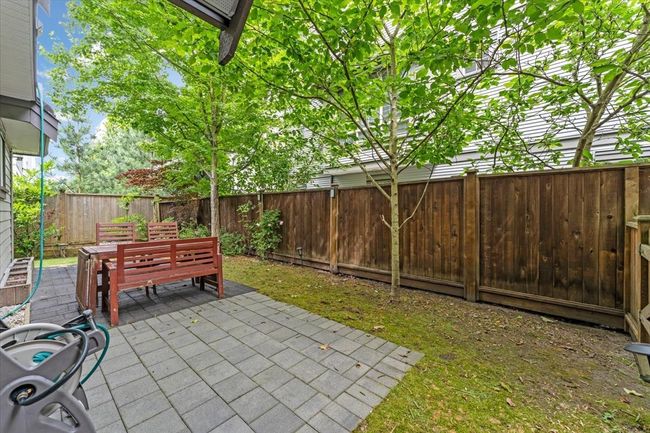 Fenced backyard with a patio area | Image 23