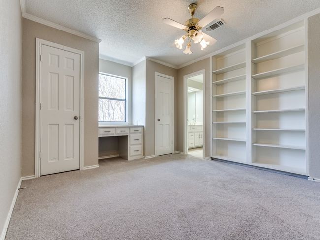 Bedroom 3 upstairs has great built in cabinets and desk, two closets, and shares a full bath with bedroom 4. | Image 27