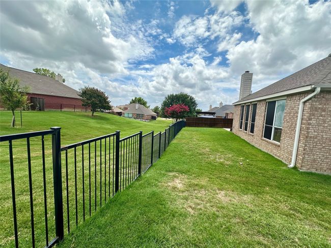 View of fenced backyard | Image 23