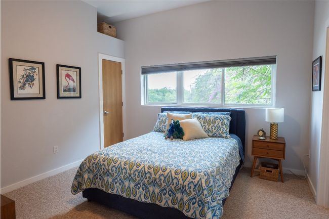 Carpeted bedroom featuring multiple windows | Image 6