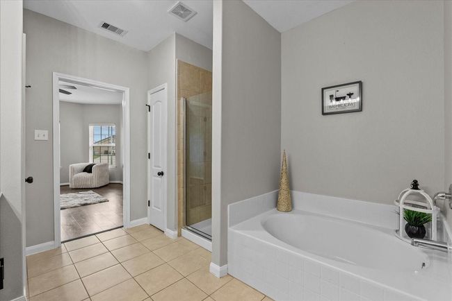 Experience spa-like tranquility in your own home with this luxurious primary ensuite and its inviting tub. | Image 19