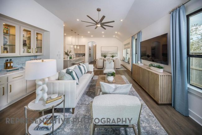 Living area with dark wood-style flooring, a ceiling fan, arched walkways, vaulted ceiling, and recessed lighting | Image 12
