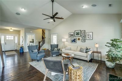 Living room with dark wood-type flooring, high vaulted ceiling, and ceiling fan | Image 3