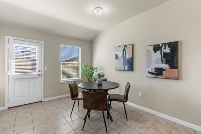 The eat-in kitchen features a spacious dining area. | Image 12