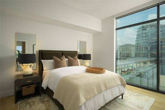 Bedroom with multiple windows, wood finished floors, and access to outside | Image 19
