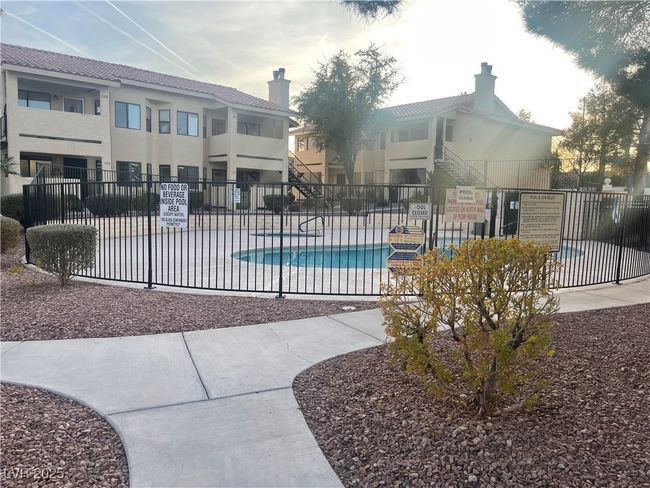Pool with a patio and fence | Image 13