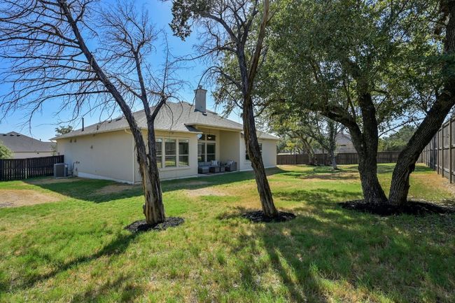 Enjoy the Texas weather in your private backyard with a covered patio, perfect for outdoor dining and relaxation. | Image 25