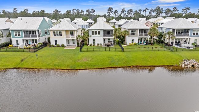 Aerial perspective of suburban area with a pond. | Image 32