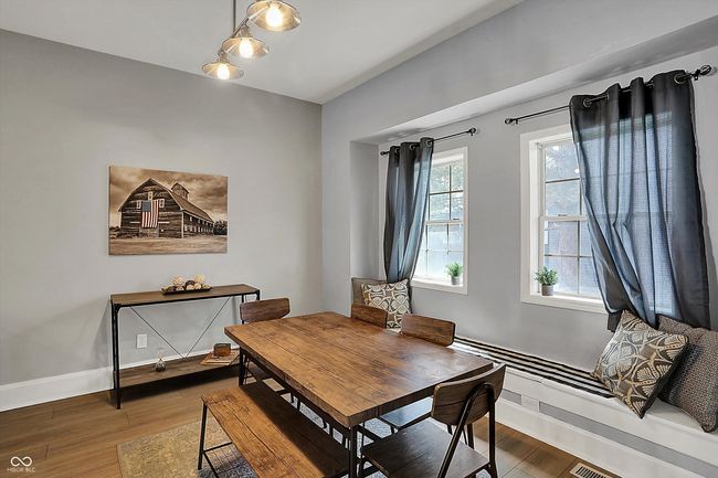 dining area featuring baseboards and wood finished floors | Image 11