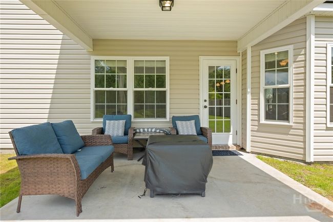 Outside relax on the covered patio. | Image 36