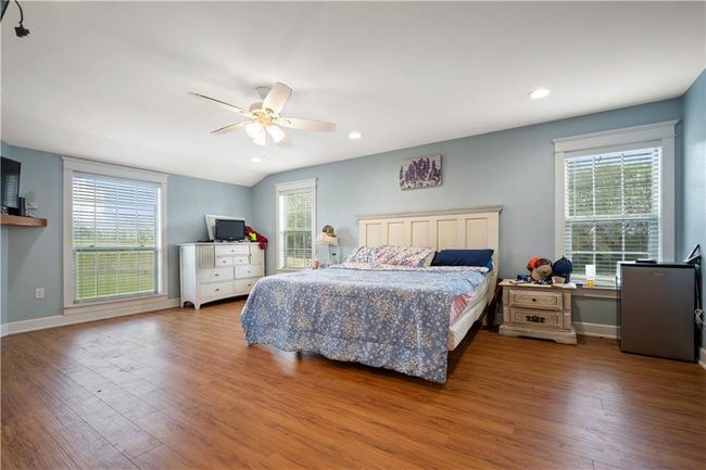 Bedroom featuring recessed lighting, baseboards, multiple windows, and wood finished floors | Image 16