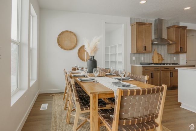 Dining room with healthy amount of natural light, baseboards, light wood-style floors, and recessed lighting | Image 12