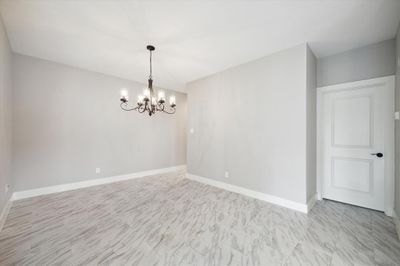 Another view of dining area. Entry hall at top, door to primary bedroom on right... | Image 3