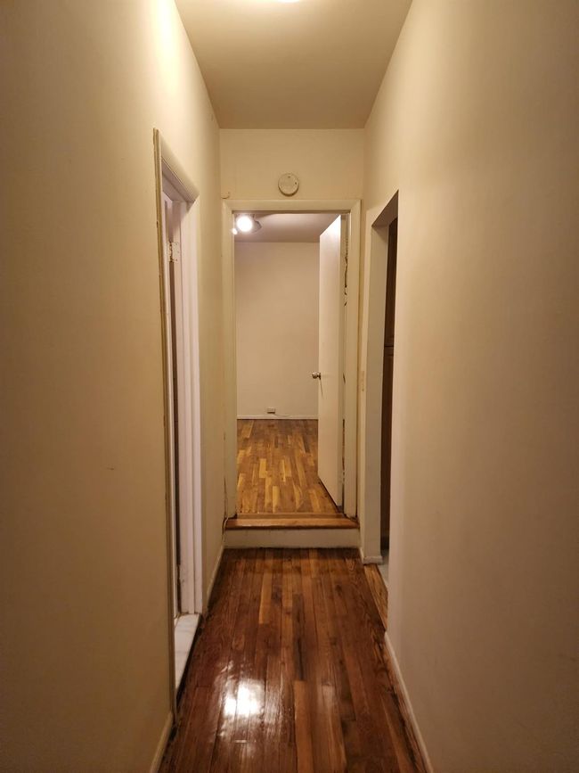 Hallway featuring wood flooring | Image 5