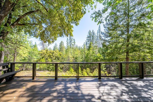 Rear deck freshly painted overlooks wooded surroundings | Image 50