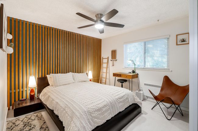 Bedroom with radiator heating unit, a textured ceiling, baseboards, and ceiling fan | Image 14