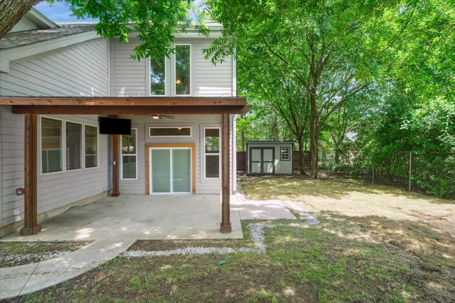 Fenced backyard with a patio area | Image 37
