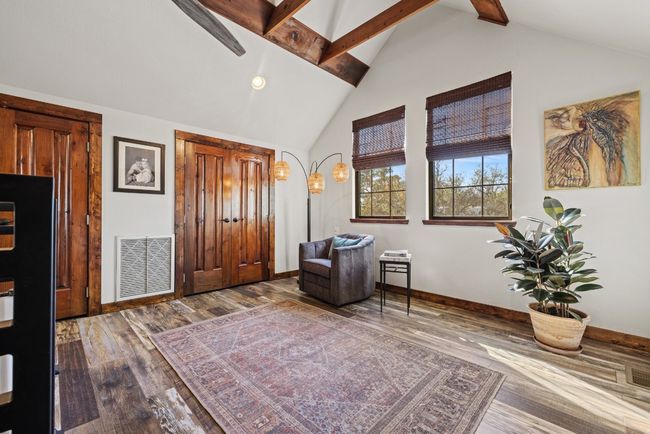Entrance foyer featuring wood finished floors, beam ceiling, and high vaulted ceiling | Image 30