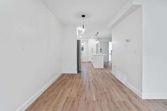 Unfurnished dining area featuring light wood-type flooring, visible vents, and baseboards | Image 20