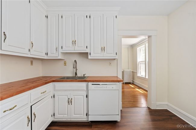Kitchen featuring, radiator, wooden counters, a sink, and wood flooring | Image 21