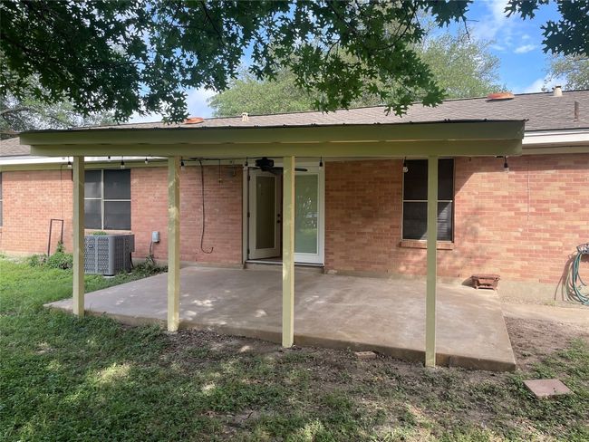 Rear view of house featuring a patio, ceiling fan, and brick siding | Image 17