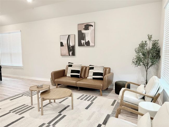 Living area featuring baseboards and wood finished floors | Image 15
